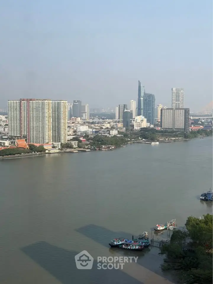Stunning riverfront cityscape view with modern high-rise buildings and serene waterway.