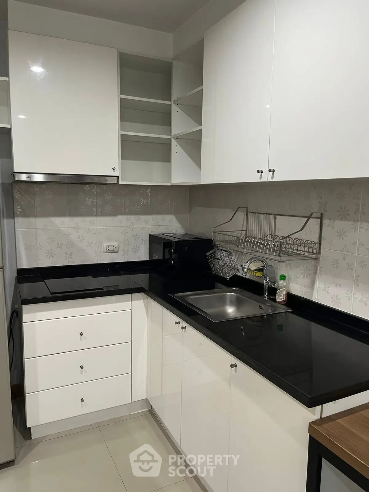 Modern kitchen with sleek black countertops and white cabinetry