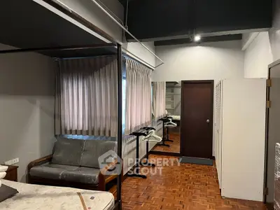 Spacious interior with parquet flooring and modern furnishings in a cozy living area.