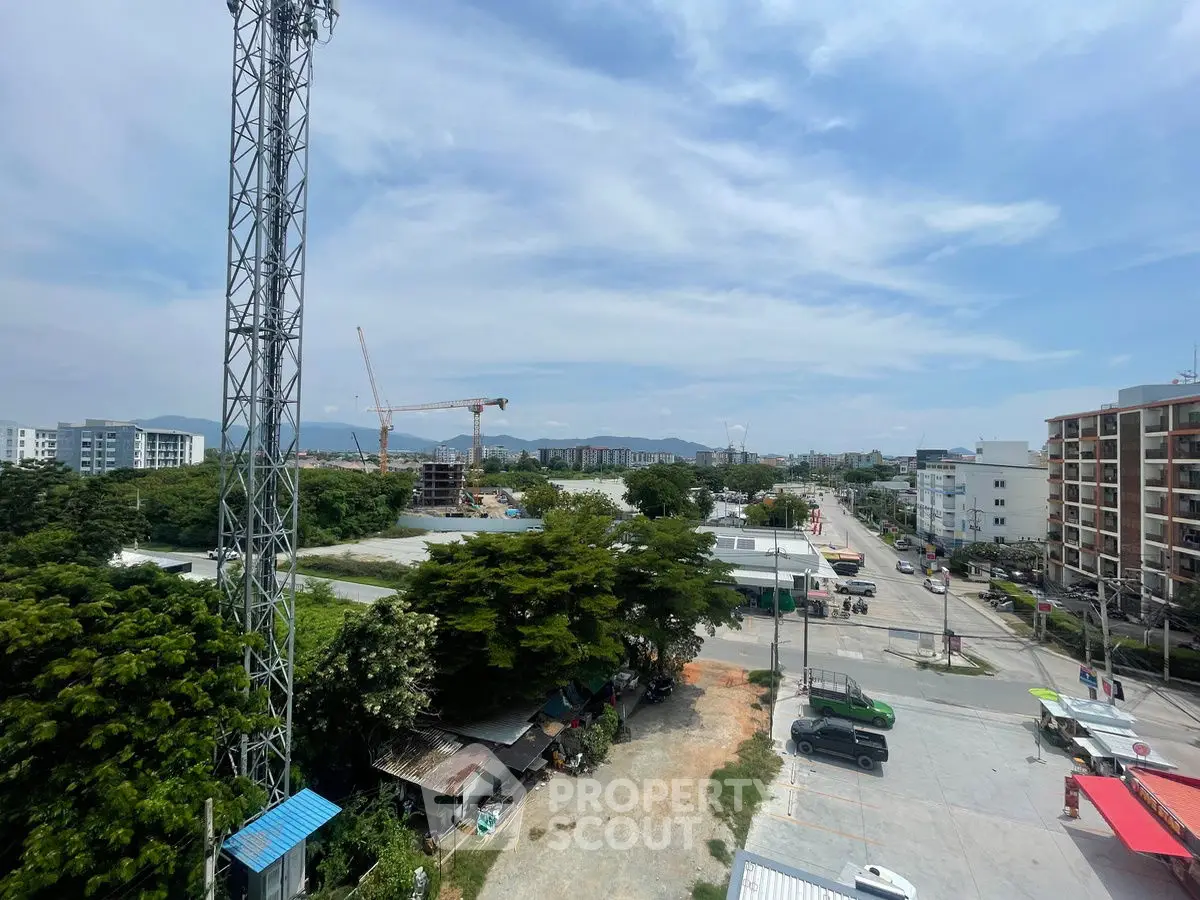 Scenic urban view with construction cranes and lush greenery, ideal for future development.