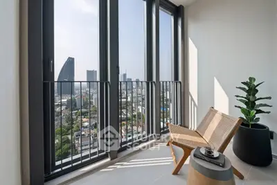 Stunning city view from modern balcony with stylish chair and plant, perfect for relaxation.