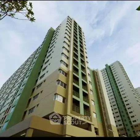 Modern high-rise residential building with sleek architecture and expansive windows.