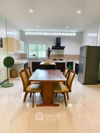 Spacious kitchen with dining area, modern appliances, and elegant decor.