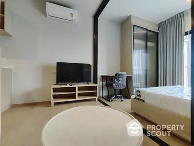 Modern studio apartment with sleek design, featuring a cozy bedroom and stylish living area.