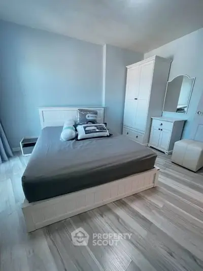 Spacious bedroom with modern furniture and elegant decor