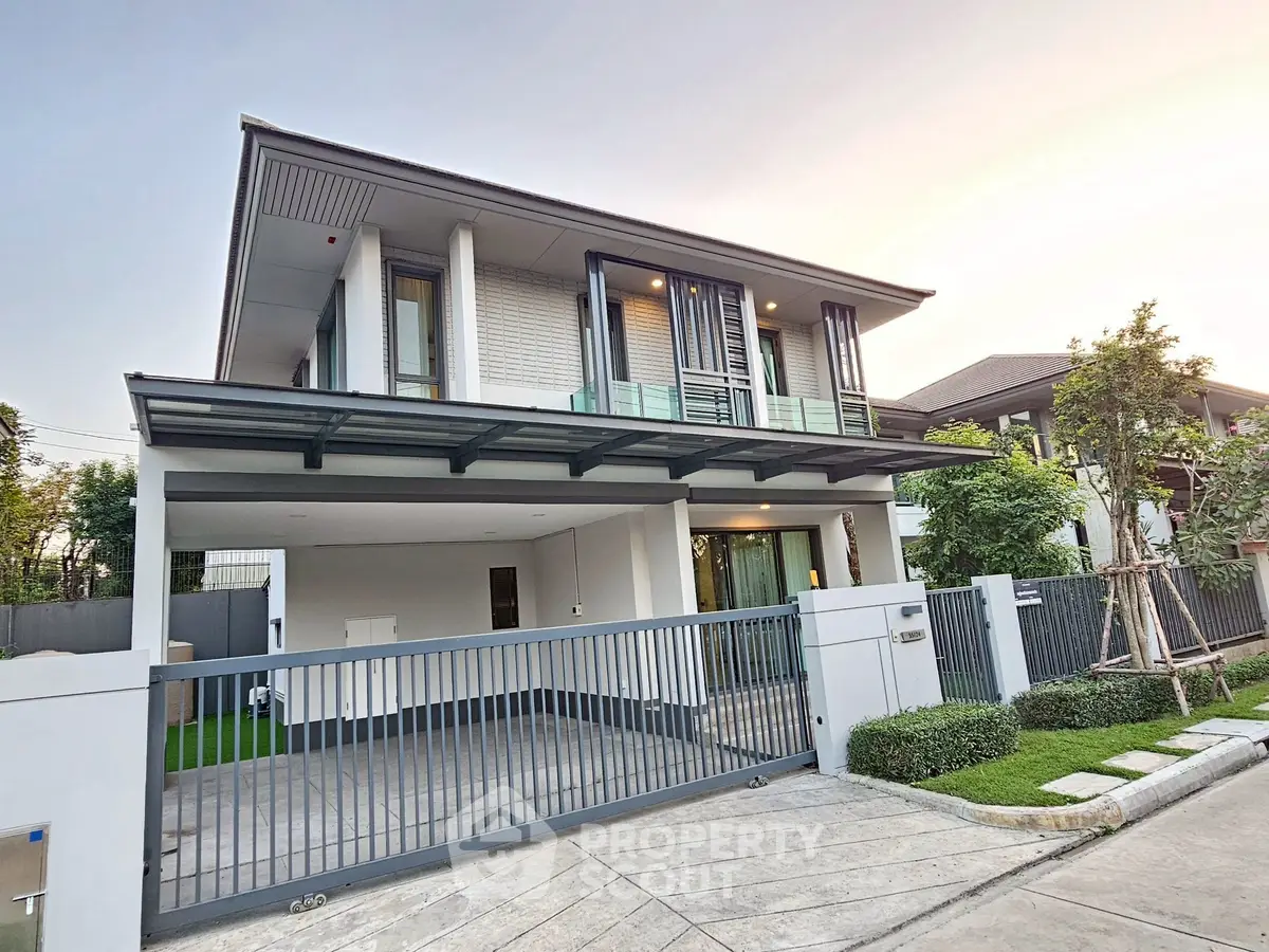Modern two-story house with sleek design and spacious driveway in a serene neighborhood.