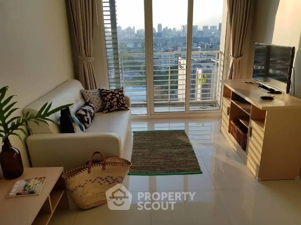 Chic living room with city view, modern furniture, and natural light in urban apartment.