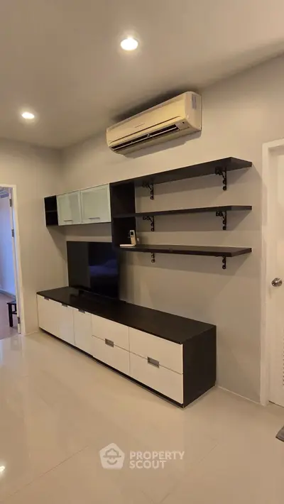 Modern living room with sleek TV unit and air conditioning, perfect for stylish urban living.