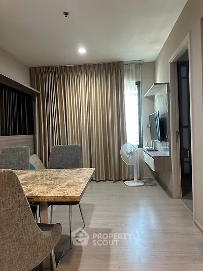 Modern living room with elegant dining area and wall-mounted TV