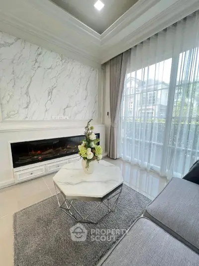 Luxurious living room with modern fireplace and elegant marble accents