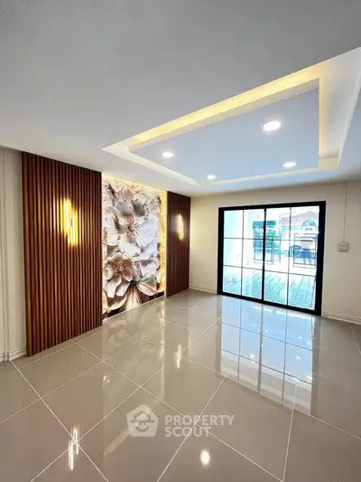 Modern living room with elegant ceiling lights and floral accent wall