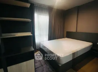 Modern bedroom with large bed and stylish shelving, featuring soft lighting and elegant curtains.