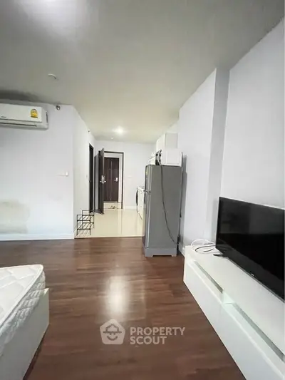 Modern apartment interior with wooden flooring and sleek furniture