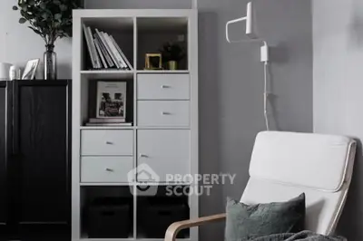 Modern living room with stylish shelving and cozy armchair