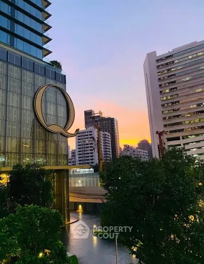 Stunning urban skyline view with modern high-rise buildings at sunset, perfect for city living enthusiasts.
