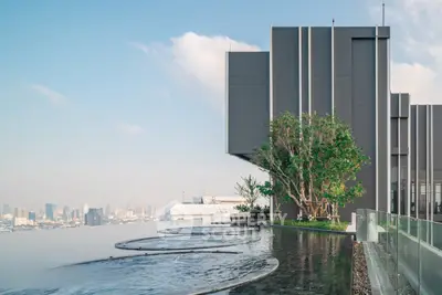 Luxurious rooftop infinity pool with stunning city skyline view, perfect for relaxation and leisure.