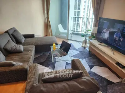Modern living room with stylish furniture and balcony view in urban apartment