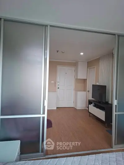 Modern apartment interior with sliding glass doors and wood flooring