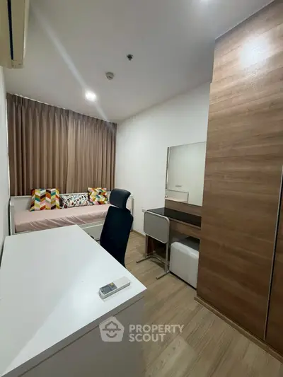 Modern bedroom with study area and stylish decor in a cozy apartment