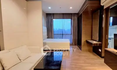 Modern studio apartment with elegant decor and large window view