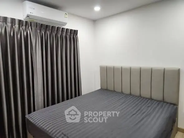 Modern bedroom with sleek design and air conditioning unit