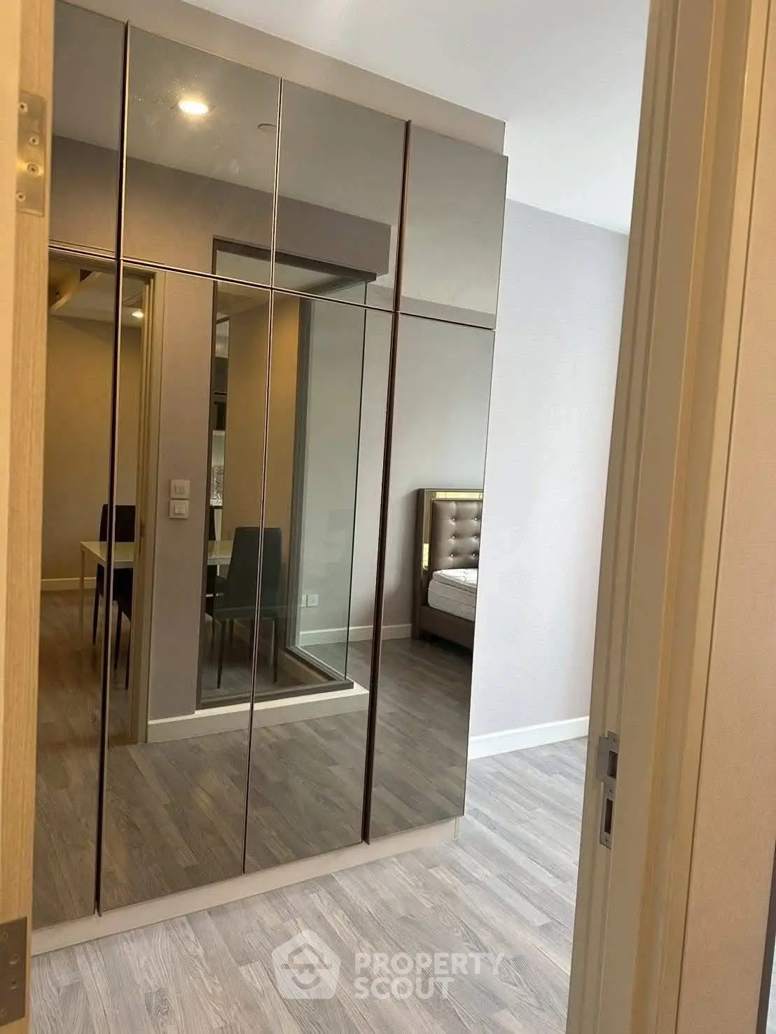 Modern bedroom with mirrored wardrobe and stylish decor