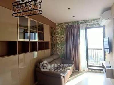 Stylish living room with modern decor and balcony view in a high-rise apartment.
