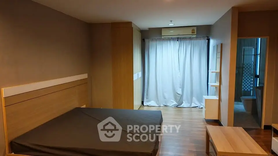 Spacious bedroom with modern design and wooden flooring