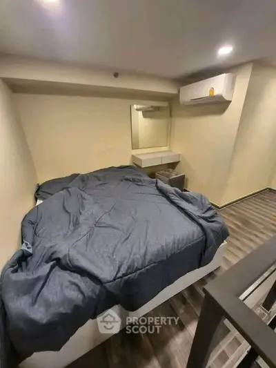 Cozy bedroom with modern design and air conditioning, perfect for urban living.