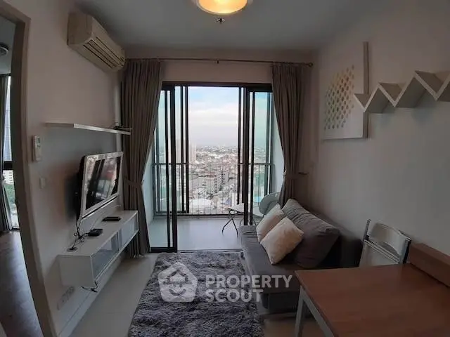 Modern living room with city view, cozy sofa, and stylish decor in high-rise apartment.