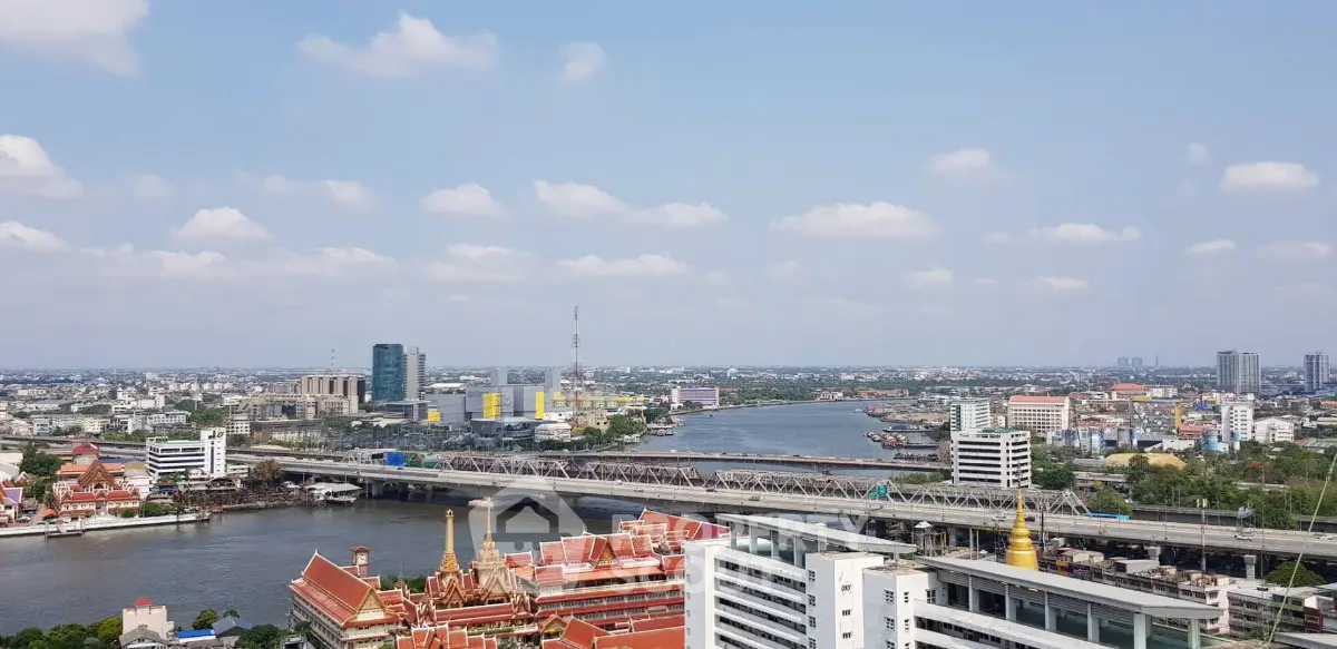 Stunning cityscape view with river and modern buildings under a clear blue sky.