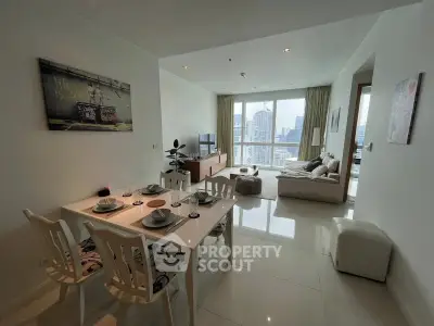 Modern living room with dining area and city view, featuring elegant decor and natural light.