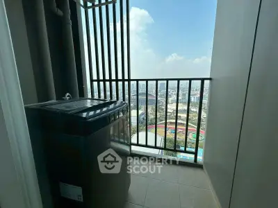 High-rise balcony with washing machine and city view, perfect for urban living.