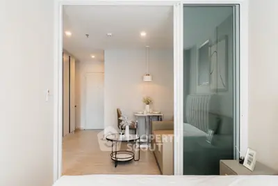 Modern open-plan living room with stylish decor and dining area in a contemporary apartment.