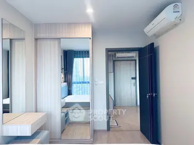 Modern bedroom with sleek design and air conditioning in a stylish apartment.