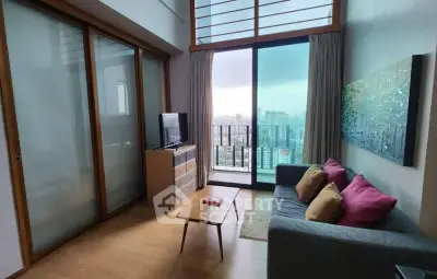 Modern living room with city view, stylish decor, and floor-to-ceiling windows in high-rise apartment.