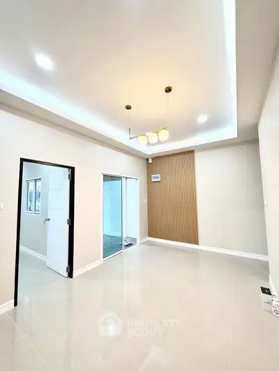 Spacious modern living room with elegant lighting and sleek tile flooring