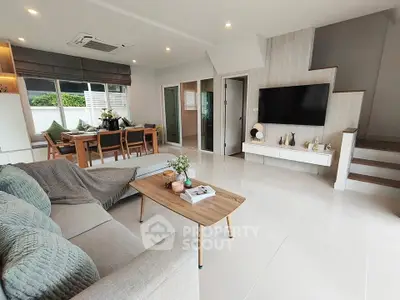 Spacious modern living room with elegant decor and open layout, perfect for family gatherings.