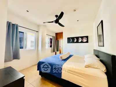 Bright and cozy bedroom with modern decor and ample natural light.