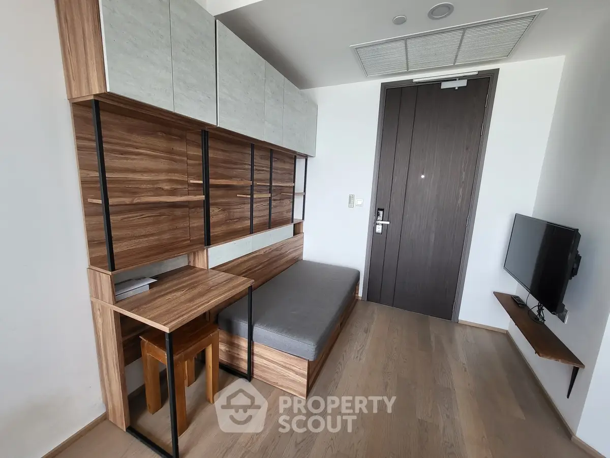Modern compact living room with stylish wood paneling and built-in furniture