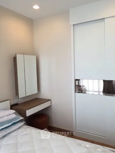 Modern bedroom with sleek wardrobe and cozy decor
