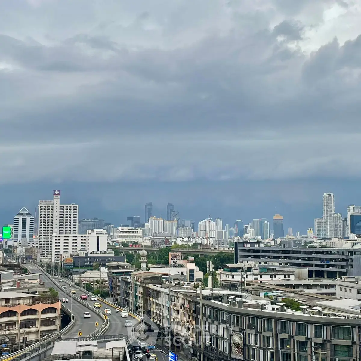 Stunning cityscape view showcasing urban skyline and bustling roads under dramatic skies.