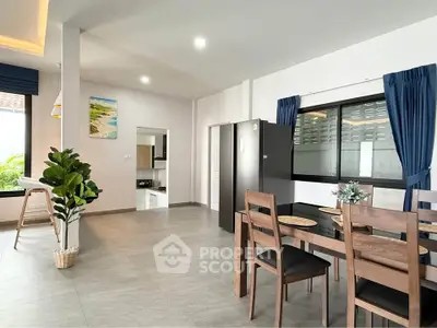 Modern open-plan dining area with sleek furniture and natural light