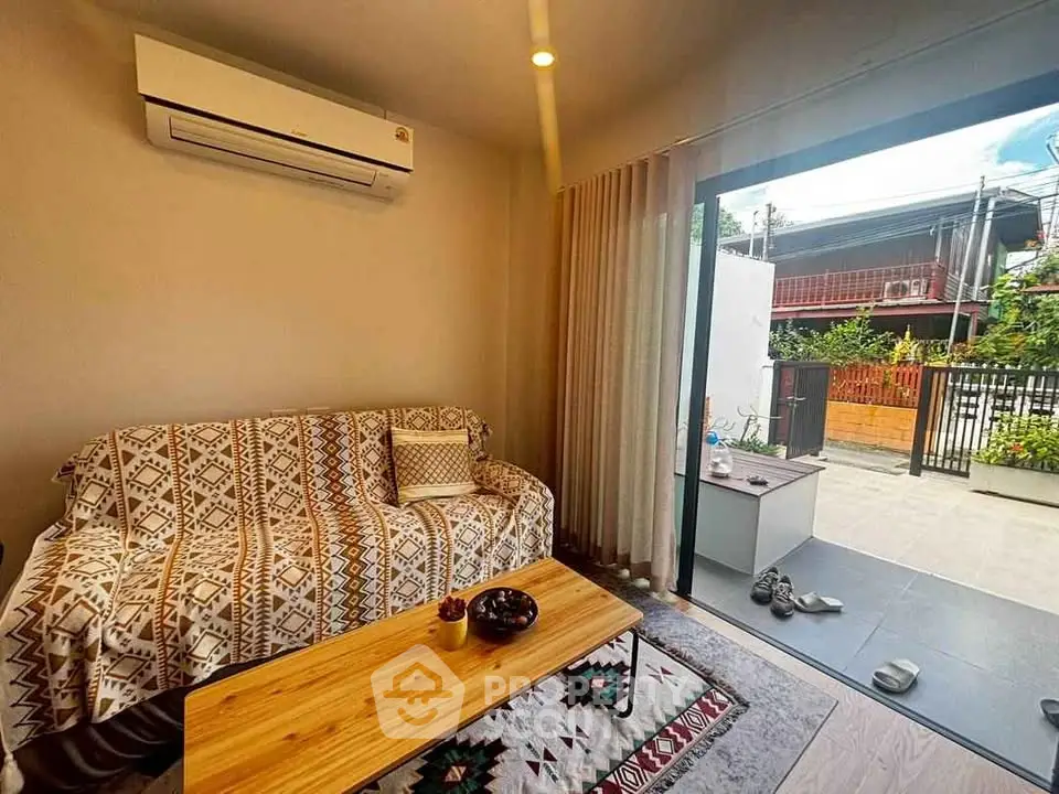 Cozy living room with air conditioning and outdoor patio access