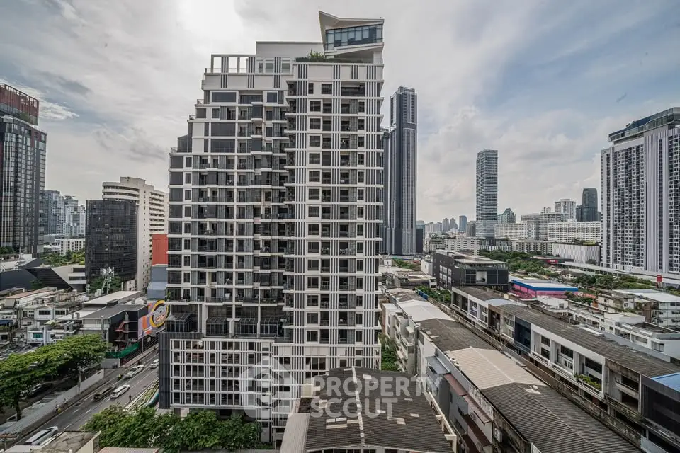 Stunning cityscape view featuring a modern high-rise building with urban skyline backdrop.