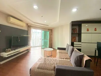 Spacious living room with modern decor and balcony access