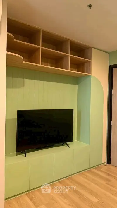 Modern living room with built-in TV unit and wooden shelves