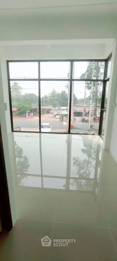 Spacious room with large windows offering a scenic view, perfect for natural light lovers.