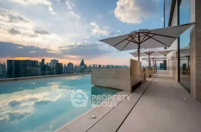 Luxurious rooftop pool with stunning city skyline view at sunset.