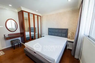 Spacious bedroom with elegant decor and ample natural light